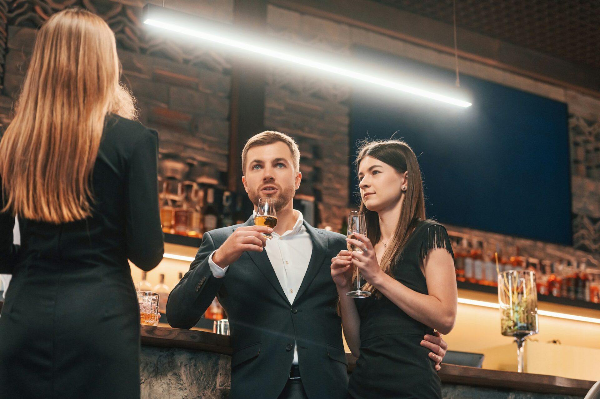 Group of people standing with glasses and celebrating event together